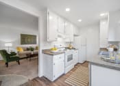 Thumbnail 9 of 32 - a white kitchen with white appliances and white cabinets