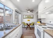 Thumbnail 8 of 32 - a kitchen with white cabinets and a counter top and a sink