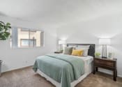 Thumbnail 14 of 32 - our apartments offer a bedroom with a bed and a window