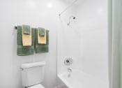 Thumbnail 20 of 32 - a bathroom with a shower and a toilet and towels