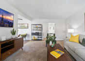 Thumbnail 7 of 32 - a living room with a couch and a coffee table