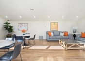 Thumbnail 26 of 34 - a living room with hardwood floors and white walls