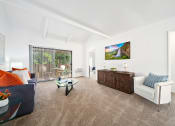 Thumbnail 8 of 34 - a living room with a couch and a chair