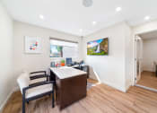 Thumbnail 22 of 32 - a home office with a desk and chairs and a window