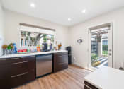 Thumbnail 23 of 32 - a kitchen with a counter and a door to a patio