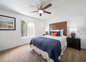 Thumbnail 25 of 34 - a bedroom with a large bed and a ceiling fan