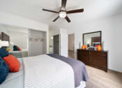 Thumbnail 22 of 34 - a bedroom with a large bed and a ceiling fan