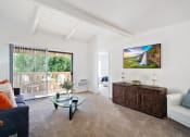 Thumbnail 6 of 34 - a living room with white walls and a glass coffee table