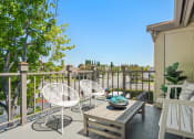 Thumbnail 40 of 61 - a patio with two chairs and a table on a balcony