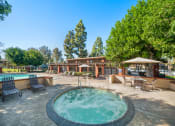 Thumbnail 33 of 34 - a pool with a hot tub and a patio with tables and chairs