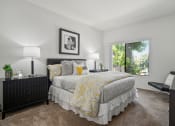 Thumbnail 35 of 61 - a bedroom with a large bed and a large window
