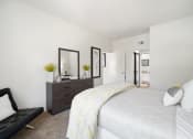 Thumbnail 37 of 61 - a bedroom with white walls and a large white bed with a yellow and white comforter