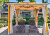 Thumbnail 60 of 61 - a patio with a gazebo and two chairs