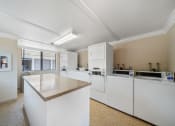 Thumbnail 26 of 61 - a kitchen with an island and washer and dryer
