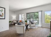 Thumbnail 3 of 61 - a living room with a sliding glass door leading to a balcony
