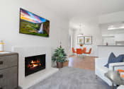 Thumbnail 4 of 61 - a living room with a fireplace and a dining room in the background