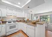 Thumbnail 8 of 61 - a kitchen with white cabinets and white appliances