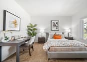 Thumbnail 11 of 61 - a bedroom with a large bed and a desk with a chair