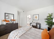 Thumbnail 13 of 61 - a bedroom with white walls and a large bed with orange pillows