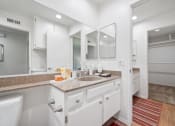 Thumbnail 15 of 61 - a bathroom with a sink and a mirror