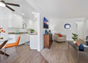 Thumbnail 7 of 19 - a living room and kitchen with a couch and a table