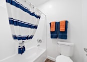 Thumbnail 10 of 41 - a bathroom with a shower and a toilet and two towels
