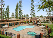 Thumbnail 15 of 41 - a courtyard with a pool and buildings with trees
