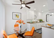 Thumbnail 17 of 19 - a kitchen and dining room with a glass table and chairs