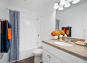 Thumbnail 5 of 19 - a bathroom with a sink and a toilet and a shower