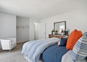 Thumbnail 15 of 19 - a bedroom with a bed and a chair and a closet