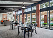 Thumbnail 32 of 41 - a dining area with a table and chairs and large windows