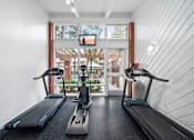 Thumbnail 27 of 41 - two treadmills and yoga machines in a gym with a view of a window