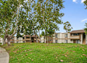 Thumbnail 39 of 41 - an exterior view of an apartment building with grass and trees
