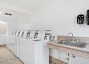 Thumbnail 36 of 41 - a washer and dryer in a laundry room with a sink