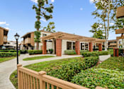 Thumbnail 17 of 41 - a courtyard with a sidewalk and a building with brick pillars