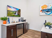 Thumbnail 22 of 41 - a kitchen with a counter and a refrigerator and a painting on the wall
