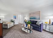 Thumbnail 4 of 28 - a living room with white walls and carpet