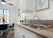 Thumbnail 13 of 28 - a kitchen with a sink and a window