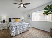 Thumbnail 8 of 28 - a bedroom with a bed and a ceiling fan