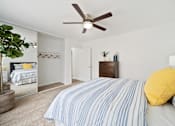 Thumbnail 7 of 28 - a bedroom with a bed and a ceiling fan