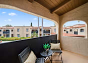 Thumbnail 16 of 28 - a balcony with two chairs and a table