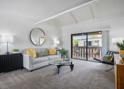 Thumbnail 5 of 29 - a living room with a couch and a glass coffee table