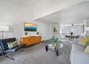 Thumbnail 8 of 29 - a living room with a couch and a glass coffee table