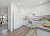 Thumbnail 17 of 29 - a renovated kitchen with white appliances and white cabinets
