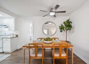 Thumbnail 3 of 29 - a dining room with a table and chairs and a ceiling fan