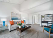 Thumbnail 2 of 40 - a living room with a couch and a coffee table