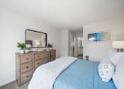 Thumbnail 21 of 29 - a bedroom with a large bed and a dresser with a mirror
