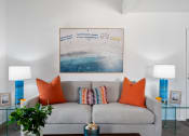 Thumbnail 4 of 40 - a living room with a gray couch and orange pillows