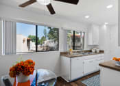 Thumbnail 6 of 40 - a kitchen with a large window and a table with a bowl of fruit