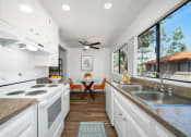 Thumbnail 8 of 40 - a kitchen with white cabinets and a sink and a window